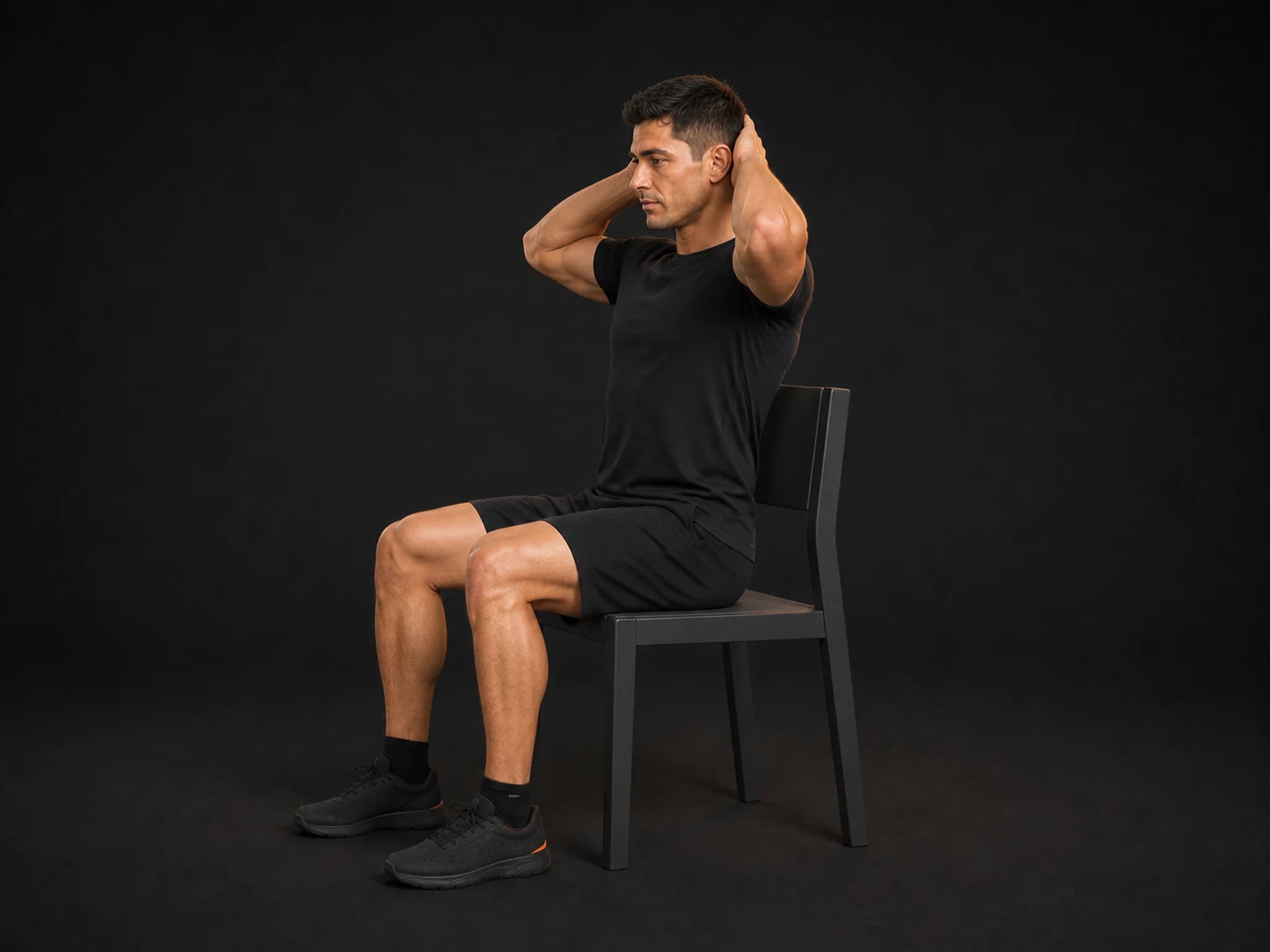 BraveREP athlete seated upright in the neutral start of a thoracic extension over a chair.