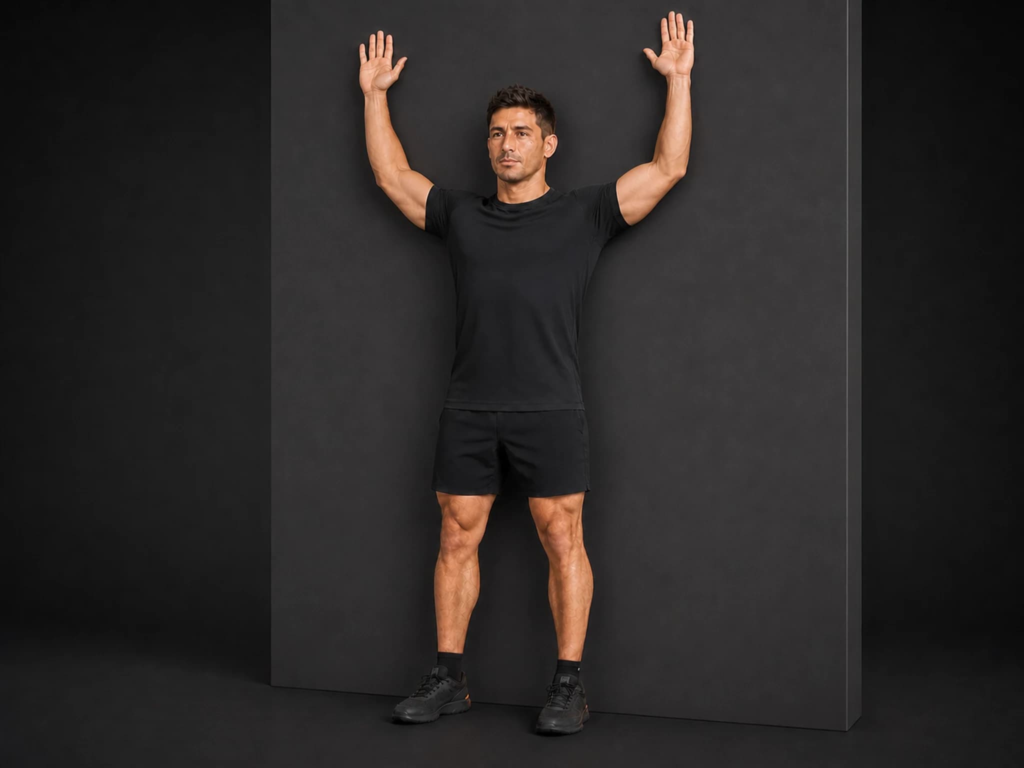 BraveREP athlete against a wall with arms extended upward at the top of a wall slide.